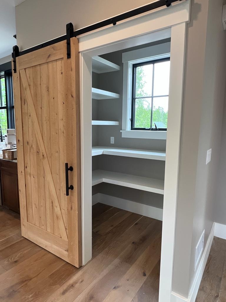 Barn door installation with custom pantry shelving