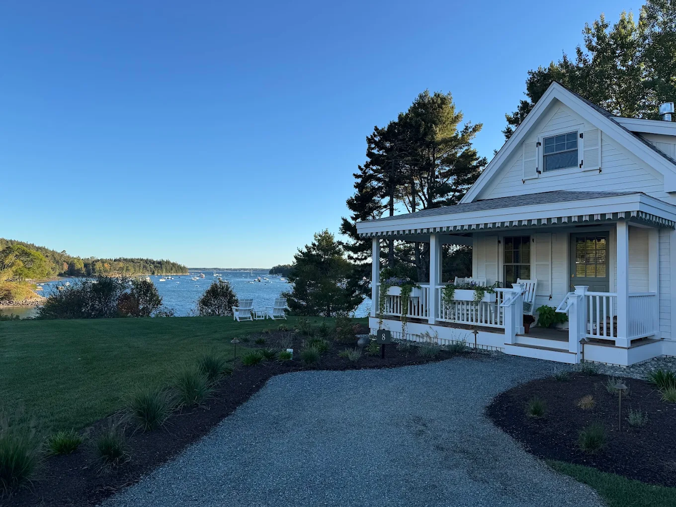 Waterfront cottage building with exterior trim and porch detail