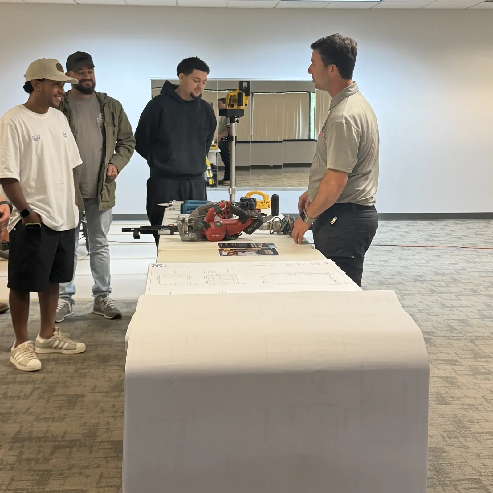 Crew members at the drawing table with the instructor during the training