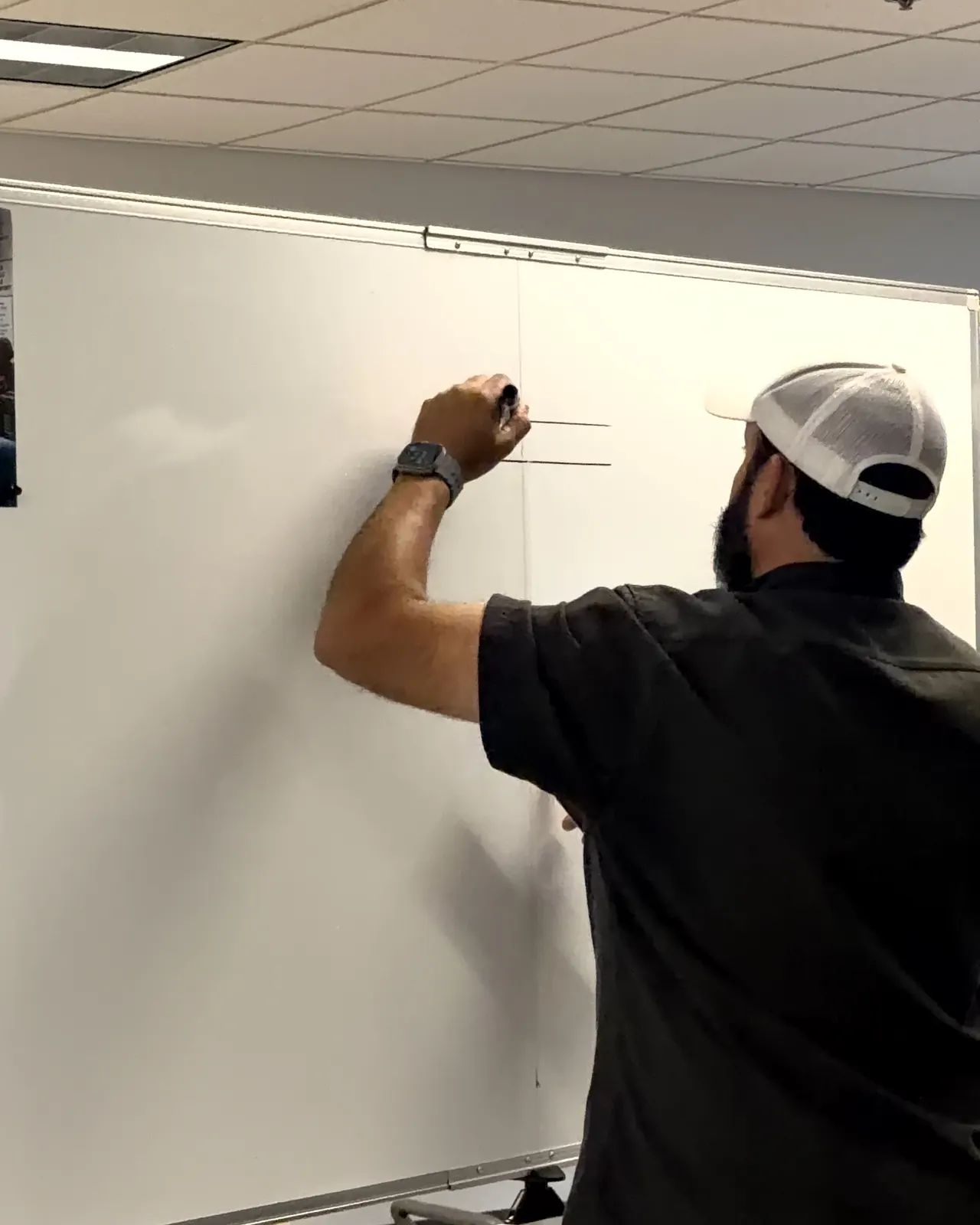Instructor drawing level reference lines on a whiteboard