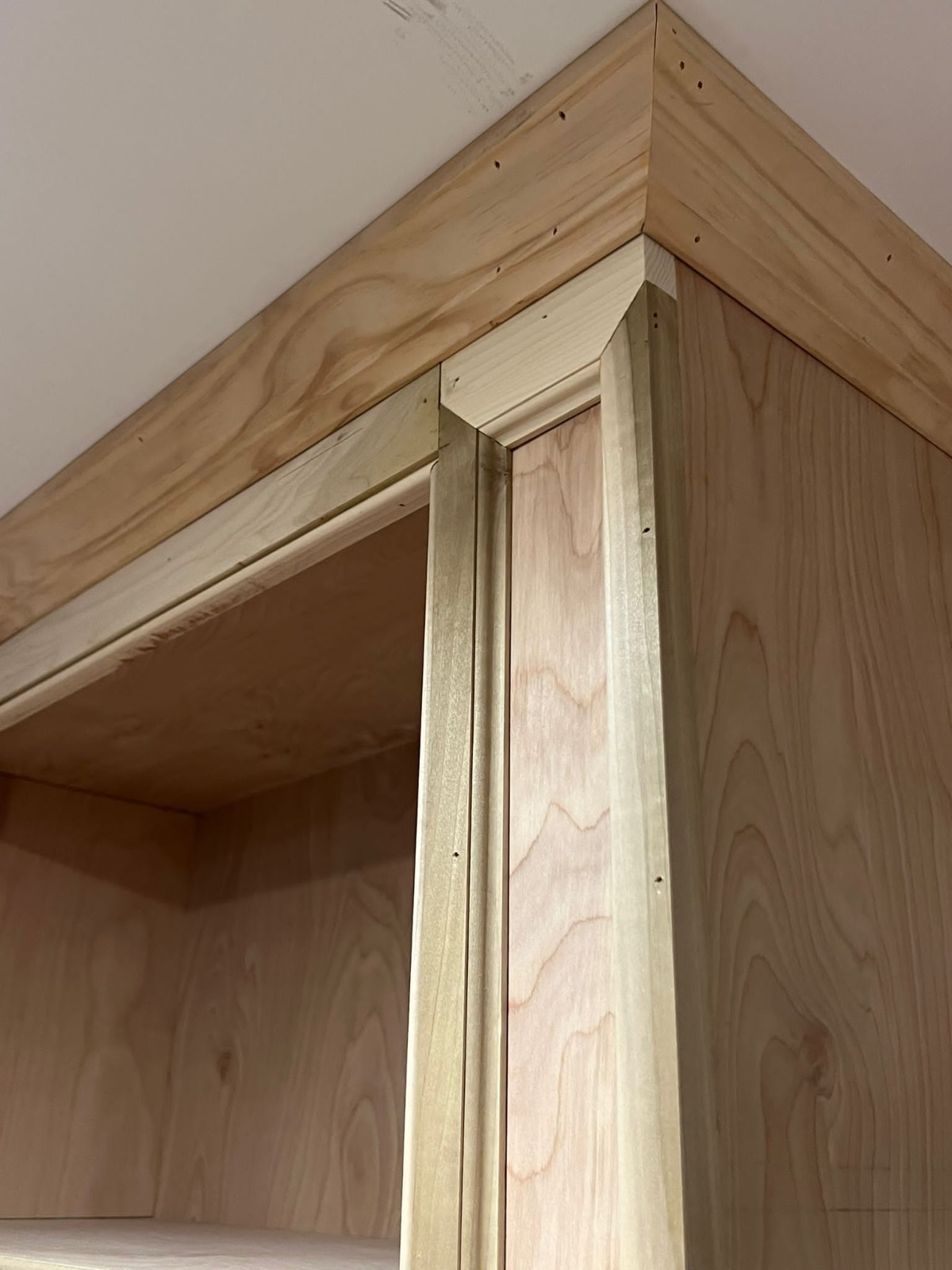 Mitered cornice on built-in casework, ready for paint