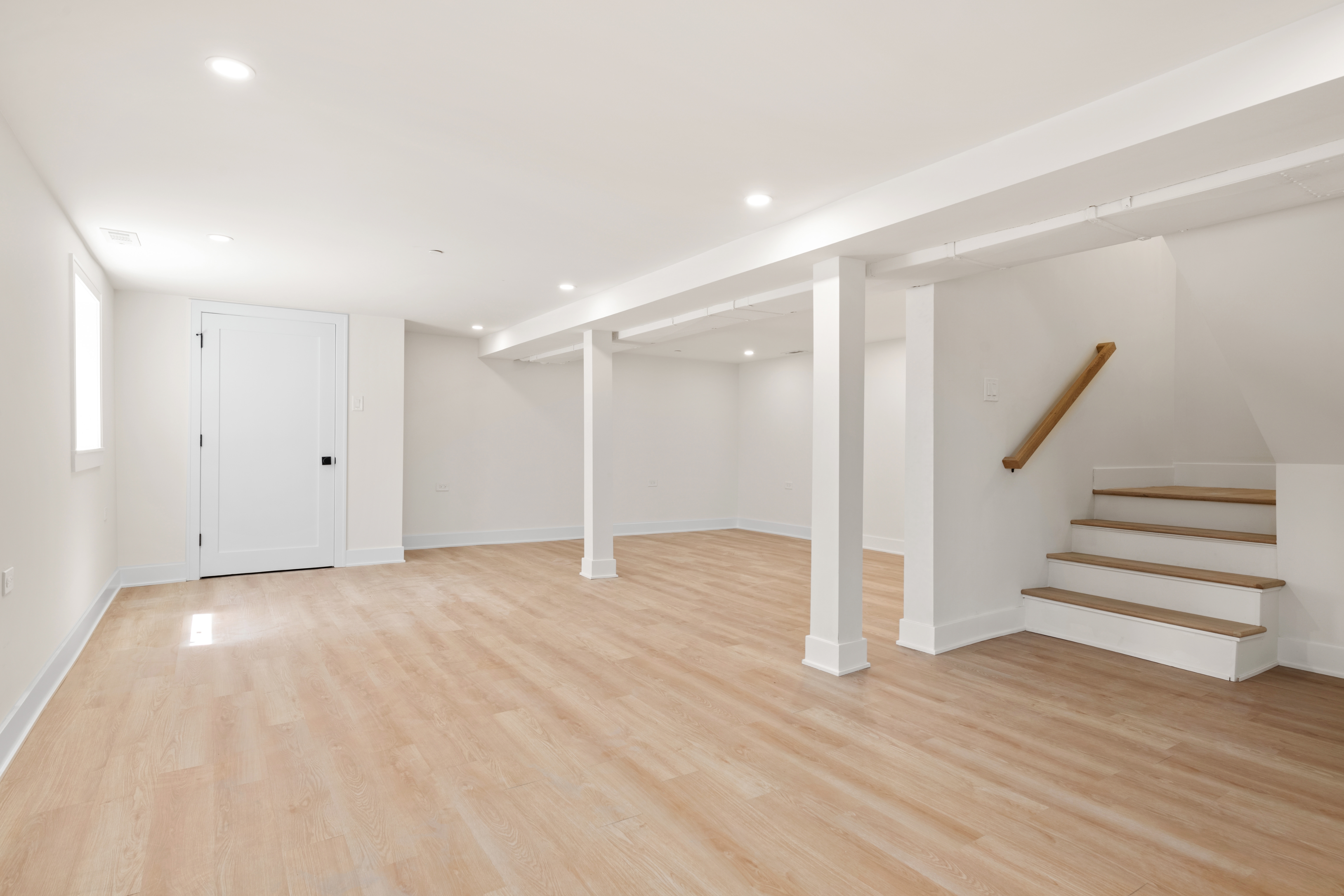 Open floor with base, column wraps, and stair railing installed
