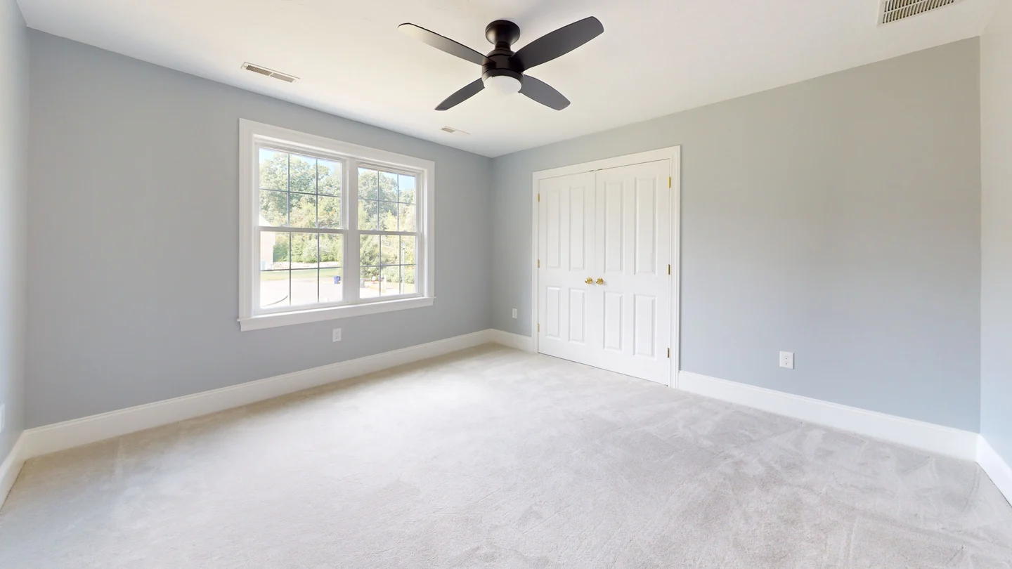Unit bedroom with closet door, base, and window casing installed