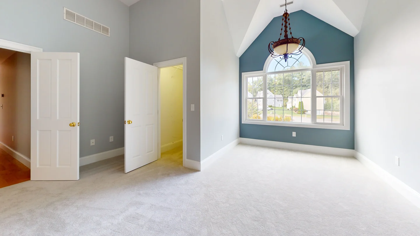 Bedroom with cathedral ceiling detail and finish trim installed